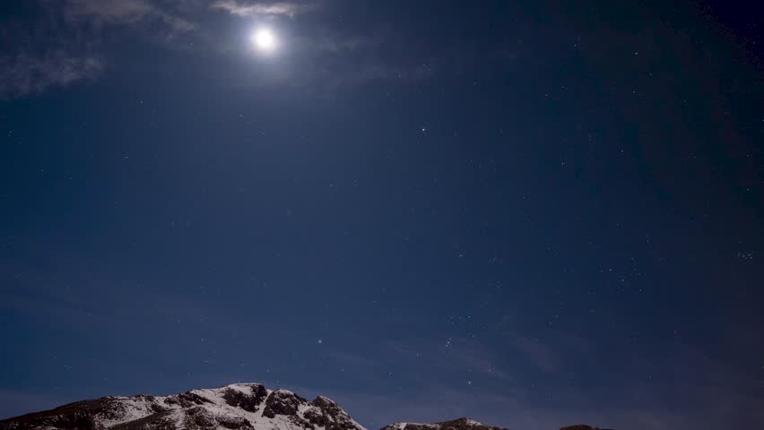 Night Sky with Bright Moon and Stars over Winter Mountain Landscape