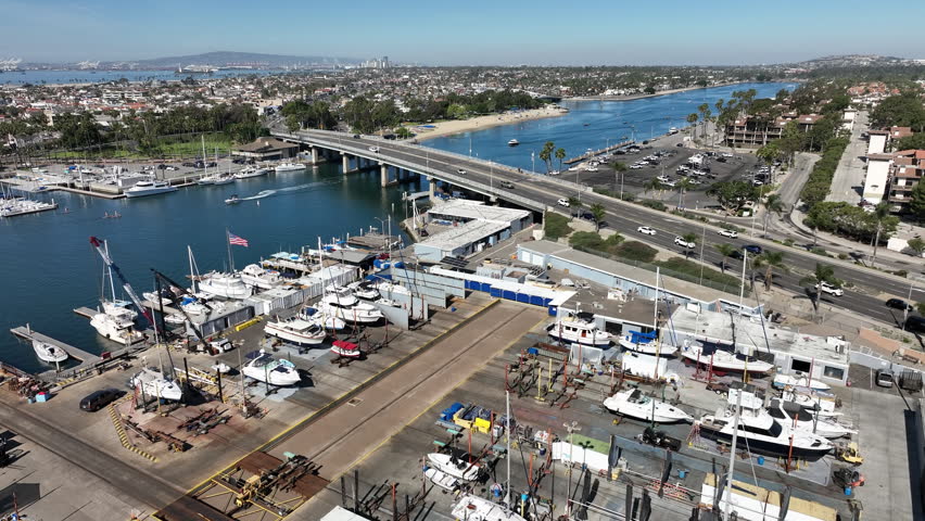Scenic aerial view of boats docked at Marina Pacifica in Long Beach, California, highlighting the waterfront near Naples and the surrounding coastal neighborhood.