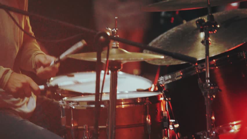 A man plays drums during a street concert