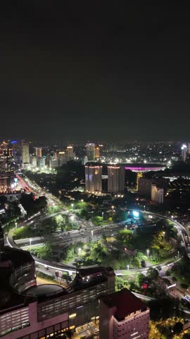 Aerial view of Jakarta cityscape featuring a river flowing through modern high rise buildings. This urban landscape highlights infrastructure, business district, and dynamic city life in Indonesia’s capital.