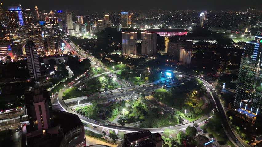 Aerial view of Jakarta cityscape featuring a river flowing through modern high rise buildings. This urban landscape highlights infrastructure, business district, and dynamic city life in Indonesia’s capital.