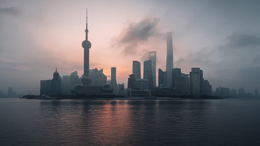 Cinematic timelapse of of golden sunrise over Shanghai skyline with Oriental Pearl Tower and iconic skyscraper on Huangpu River in Pudong district, China