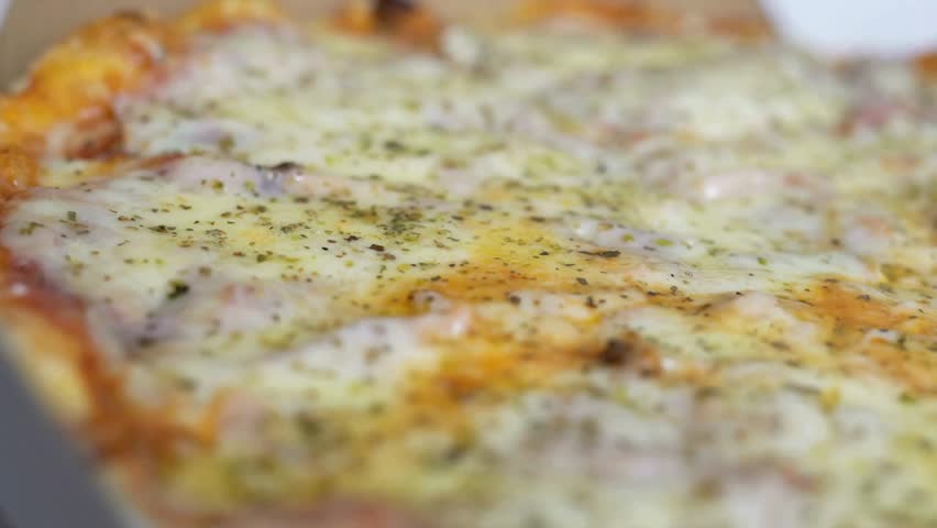 Meal time at pizzeria, man taking a slice of the pizza shot with very thin depth of field. Frame. Hand cut slice of pizza and take it, close up,