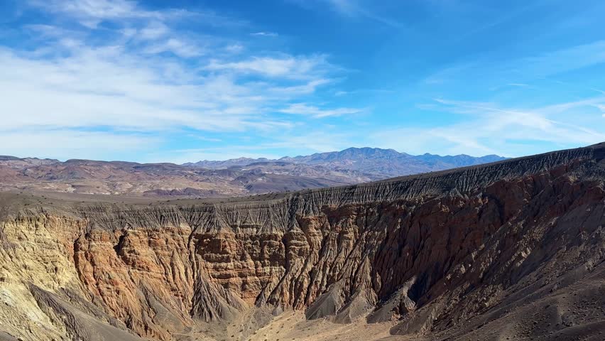 Handheld wide booming down shot of the volcanic Ubehebe Crater in Death Valley National Park, California. 4K