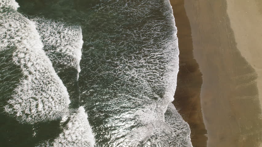 Waves breaking along the sandy coastline of Ostional Beach in Costa Rica