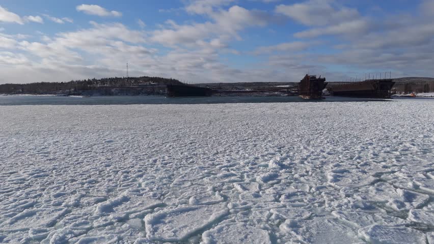 Beautiful afternoon during a warm sunset over frozen surface in two Harbors, Minnesota 4
