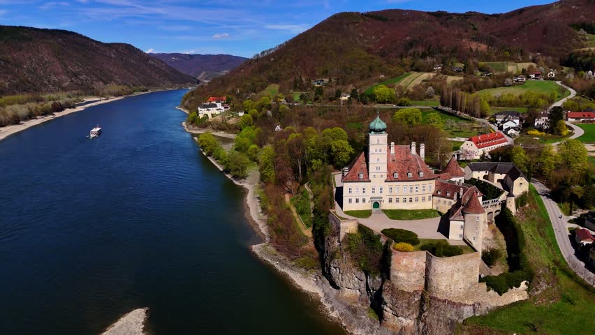 Scenic Drone Footage of Historic Schönbühel Castle on the Danube River Surrounded by Nature in Austria.