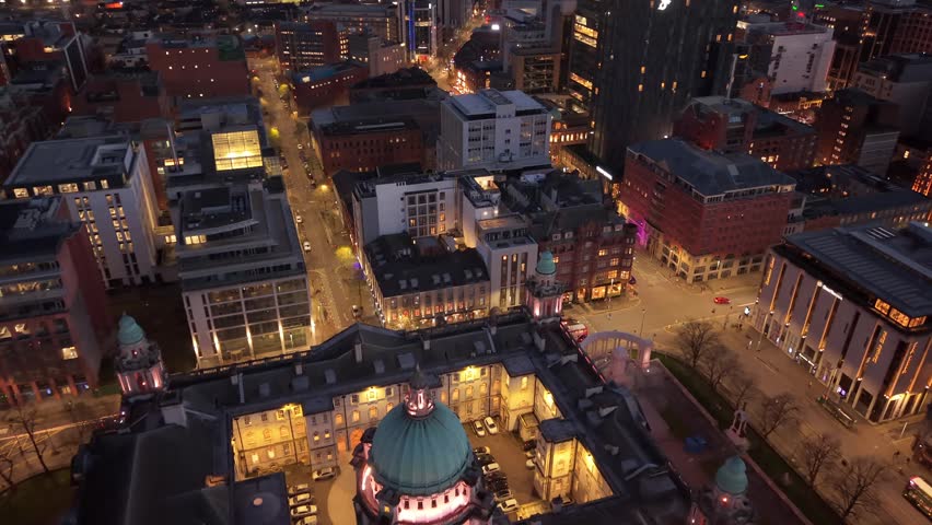 Reversing 4K 60FPS aerial reveal GV of Belfast City Hall in Belfast City Centre, Northern Ireland at night. Produced with Rec709 color.
