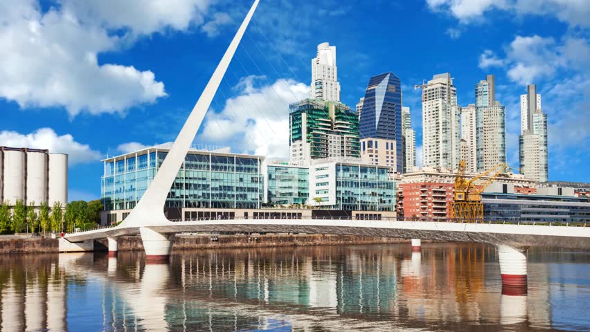 View of Puerto Madero District with Bridge over Calm Water with Blue Sky in Buenos Aires, ArgentinaEmbankment and portin city of Buenos Aires, coast of gulf La Plata. Buenos  ArgentinaArgentina, Aires Province, City  View of Puente de la Mujer in Puerto Madero.
