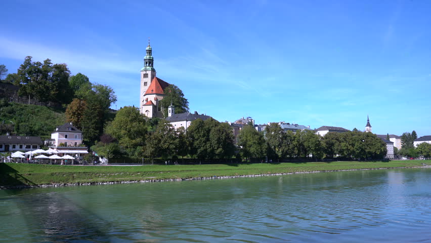 The Salzach River flowing through Salzburg Austria 4K UHD. People enjoying the Salzach River flowing through Salzburg Austria. 4K, UHD.
