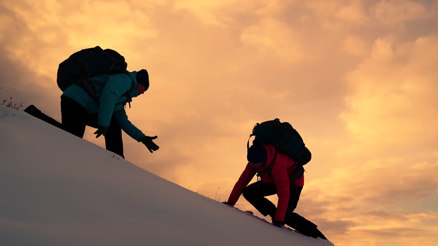 Tourists and rock climbers reach top of hill, on mountain vacation. Business team victory. Teamwork business people. Achieve your goal. Travelers climb mountain, lending helping hand to each other
