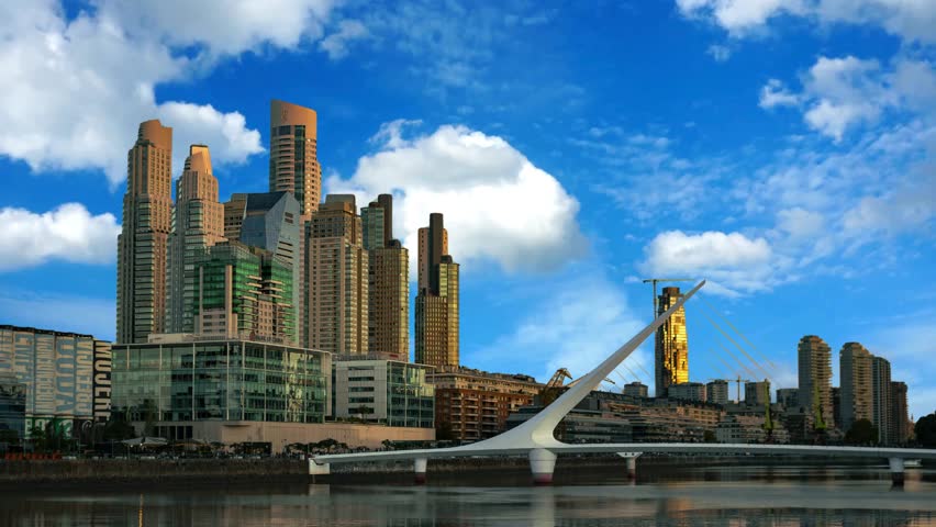 View of Puerto Madero District with Bridge over Calm Water with Blue Sky in Buenos Aires, ArgentinaEmbankment and portin city of Buenos Aires, coast of gulf La Plata. Buenos  ArgentinaArgentina, Aires Province, City  View of Puente de la Mujer in Puerto Madero.