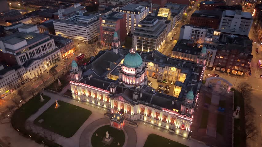 Clockwise 4K 60FPS aerial GV of Belfast City Hall in Belfast City Centre, Northern Ireland at night. Produced with Rec709 color.