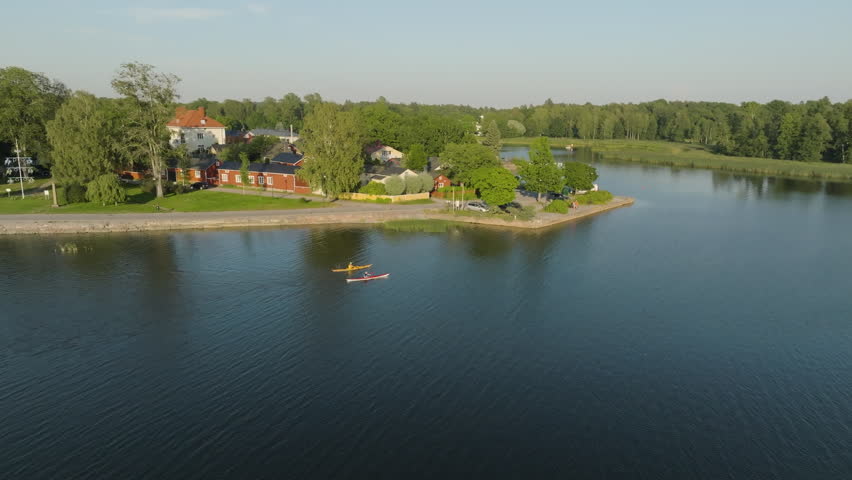 Aerial view of tourists kayaking in front of Tammisaari city, summer in Finland