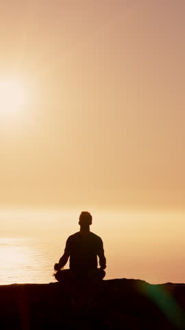 Outdoor, mindfulness and man at beach for meditation, calm and routine for peace on summer vacation. Silhouette, mockup space and person in nature, mental health and sunrise on holiday and ocean