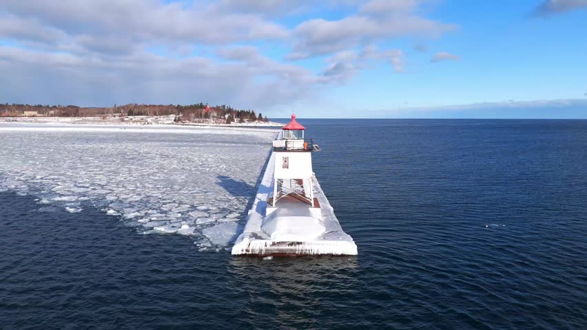 Two Harbors Minnesota during a winter cold day in Lake Superior with ice formations with lighthouse