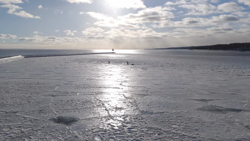 Beautiful afternoon during a warm sunset over frozen surface in two Harbors, Minnesota 7