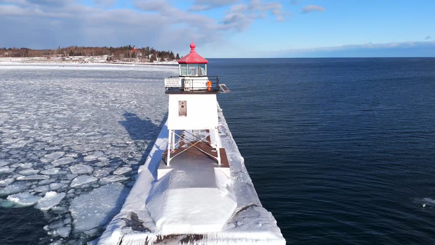 Light house in Two Harbors Minnesota during a winter cold day in Lake Superior with ice formations