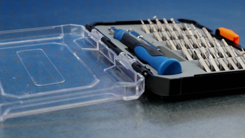 A set of metal bits for installation work in a plastic case.