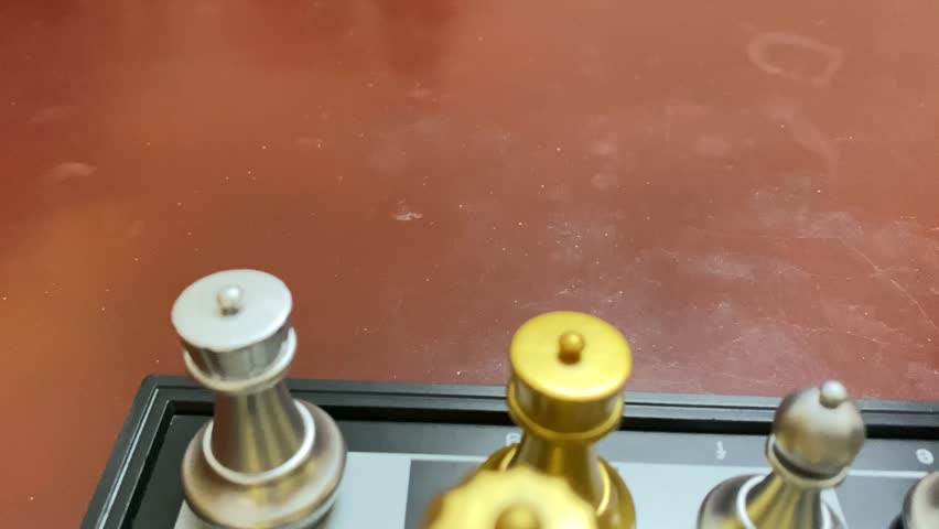 Close up view of silver and gold Chess set on classic black white board