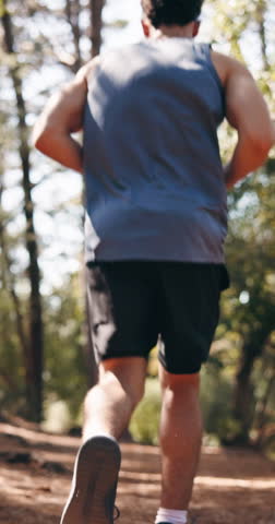 Man, fitness or running with shoes in forest for outdoor workout, cardio exercise or training. Back view, male person or active runner sprinting with sneakers in woods for physical activity in nature
