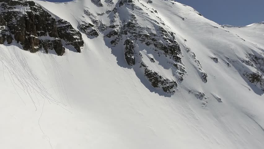 Aerial winter panorama shows snowy Alps mountain ridges and glaciers across vast peaks. Cinematic high altitude scenery reveals pristine white summits, icy slopes, remote European wilderness. Alps, Alpine, and Snow reveal landscape character, environmental detail, and a strong sense of place. The footage supports nature, travel, scenery, environment, and destination related searches. Clear natural textures and recognizable terrain make the clip useful for documentary and tourism projects.