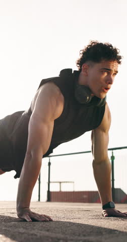Outdoor, push up and man with exercise, training for health benefits or endurance. Person, morning routine or athlete in city, sunshine or balance with energy, cardio or workout for wellness or space