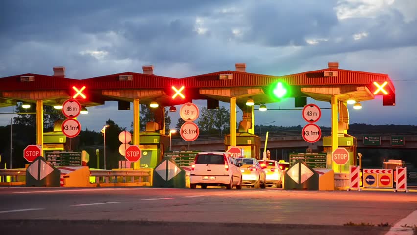 Highway Car Pay toll at sunrise, Night lights and Autos passing through toll