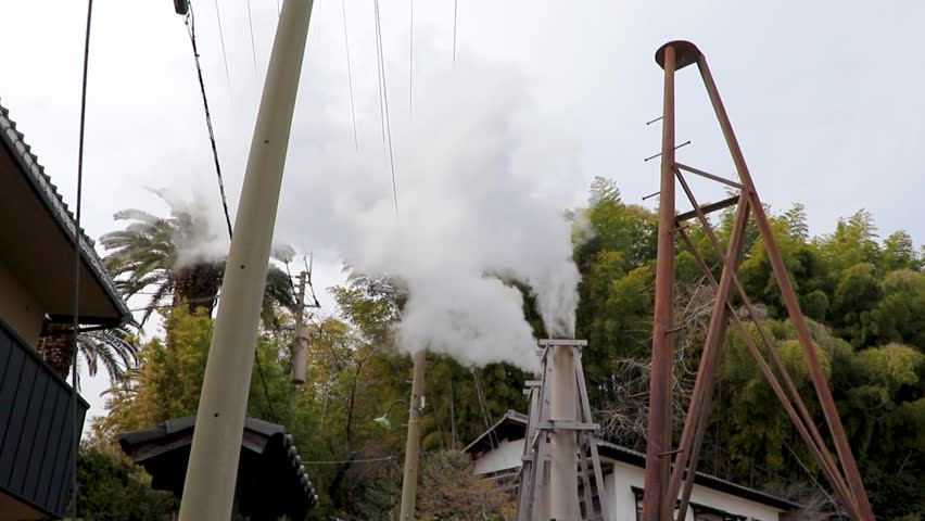 White steam rising from the chimney of a hot spring town