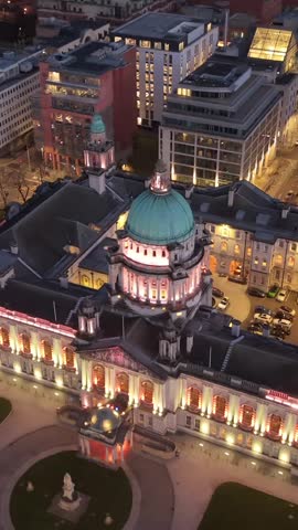 Close-up 4K 60FPS aerial GV of Belfast City Hall in Belfast City Centre, Northern Ireland at night. Produced with Rec709 color.
