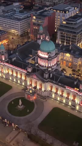 Clockwise 4K 60FPS aerial GV of Belfast City Hall in Belfast City Centre, Northern Ireland at night. Produced with Rec709 color.