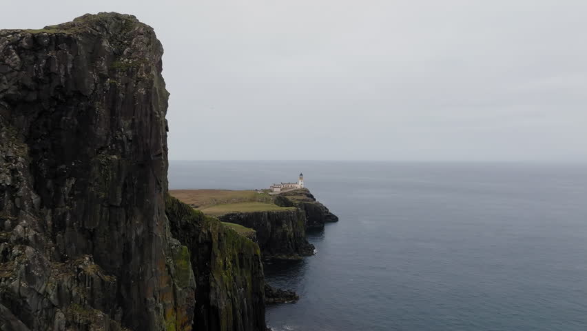 Neist Point Lighthouse on Isle of Skye overlooking the Atlantic Ocean, Scotland, Aerial tracking shot