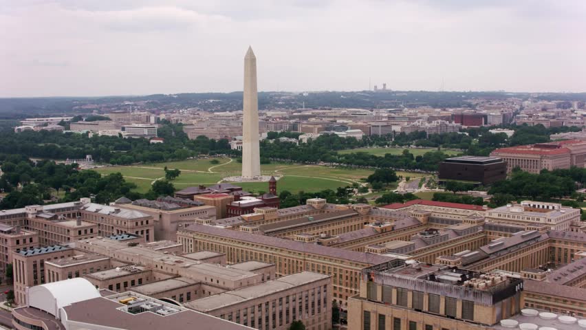 Cinematic aerial drone footage of the towering Washington Monument and the expansive National Mall in Washington, D.C.