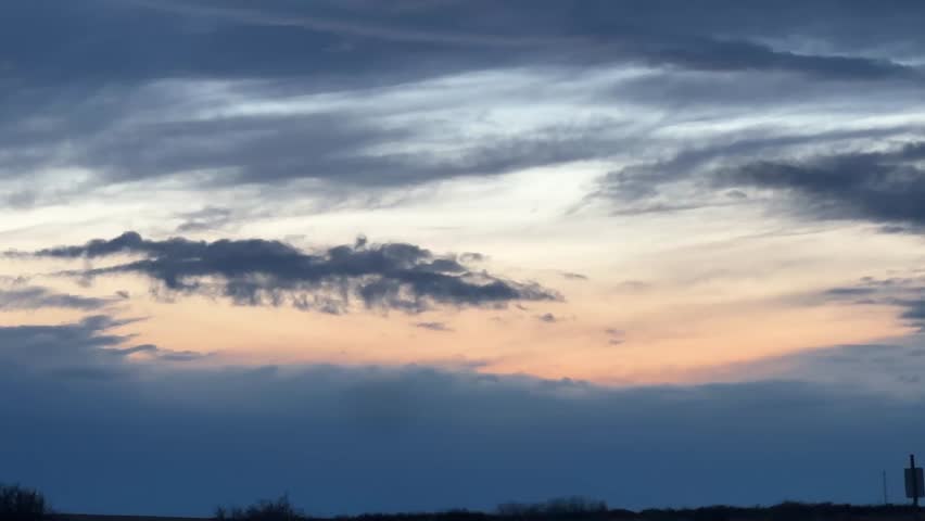 Sunset at dusk in Alberta with warm sky colors and fading light over open prairie landscape