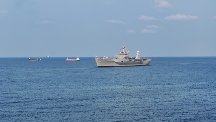 modern naval ship sailing on the open blue ocean. Concept of maritime defense, national security, and military naval infrastructure in a professional setting.