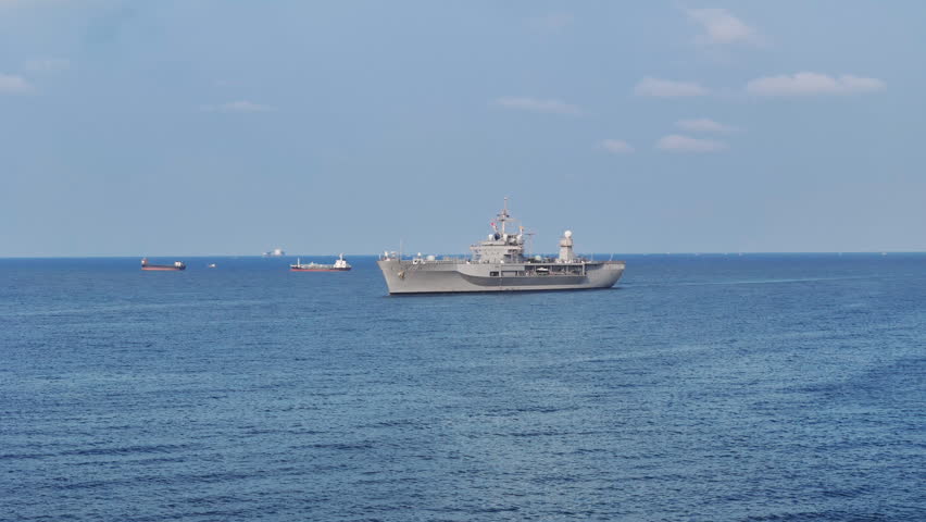 modern naval ship sailing on the open blue ocean. Concept of maritime defense, national security, and military naval infrastructure in a professional setting.