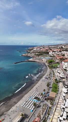 Aerial drone video of Costa Adeje coastline with beach, resorts and turquoise ocean, popular travel destination in Tenerife Canary Islands Spain