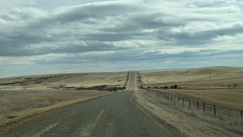POV Driving On Dirt Road Through Rural Landscape Showing Unpaved Terrain And Countryside Travel Scene