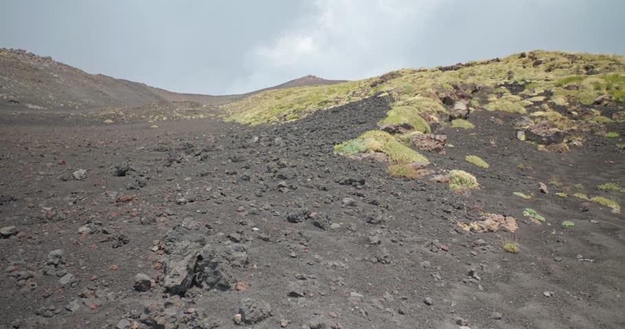 Landscape view of the dark volcanic hills and dry grass near Etna Volcano, 4k