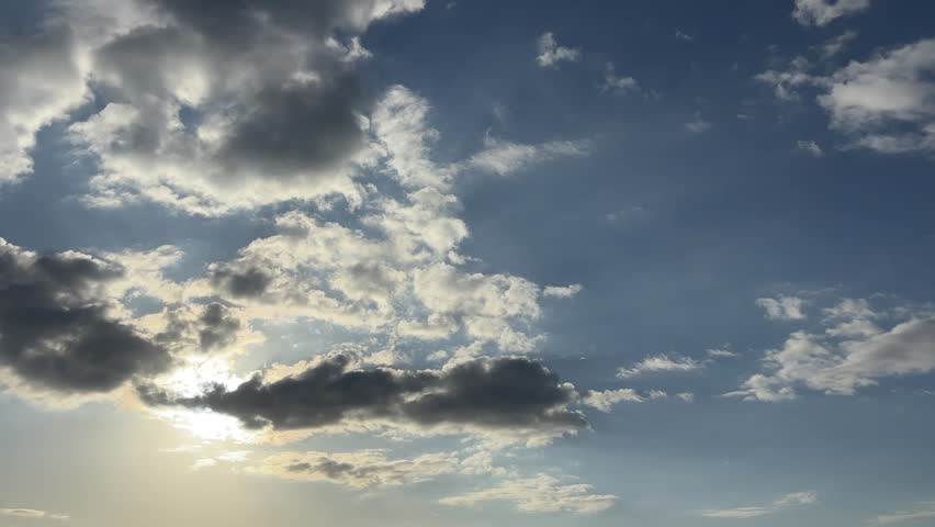 Dramatic blue sky with white clouds and rays of light