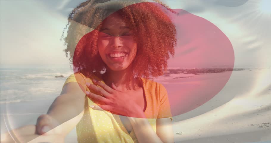 Vertical video: Hand offering, yellow-top woman leading partner toward ocean, red white overlay. Beach, couple, romance, candid, outdoor, waves, horizon