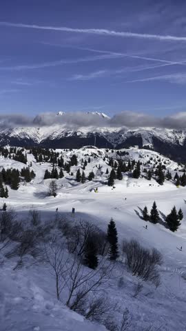 Majestic Alpine Winter Landscape with Snowy Ski Slopes, Pine Trees and Mountain Peaks