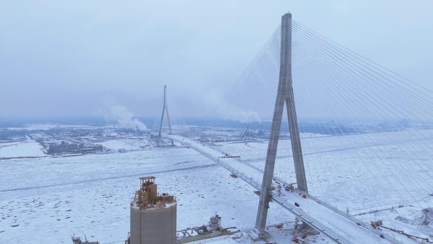 Gordie Howe International bridge over a frozen Detroit river in Detroit, Michigan, USA