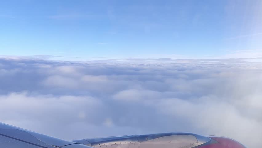Flying on a plane, looking at the clouds from above