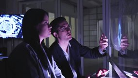 A professional man interacts with a high-tech circular data interface on a large digital screen, featuring graphs and data elements in a glowing blue theme. - Powered by Shutterstock - Get 15% off with code: PIKWIZARD15