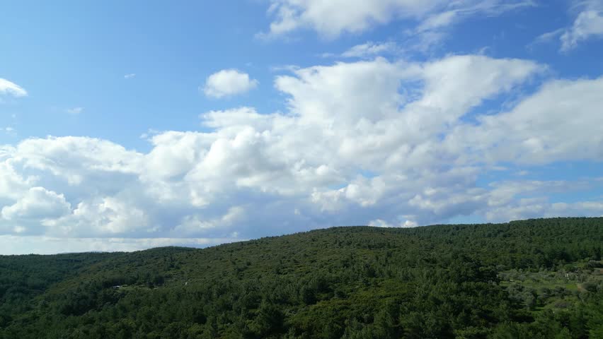 Aerial Drone View Of Green Hills And Coastline Under Dramatic Clouds