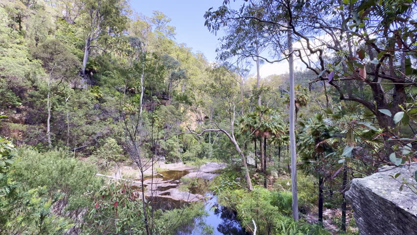 Rainbow Falls Rock pool and cascade waterfall at Blackdown Tablelands, an oasis in the outback and popular travel destination for bush walk and camping in Queensland Australia.
