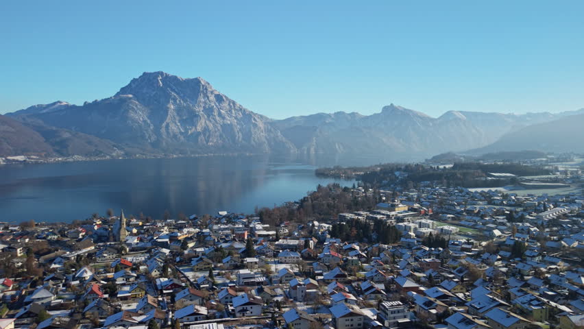 Aerial view of snowy Altmünster village, Traunsee lake and Alps in winter, Austria