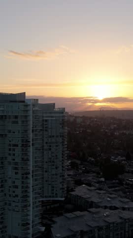 Breathtaking Sunset Over New Westminster, British Columbia: Aerial View of a Modern Cityscape with Residential Buildings