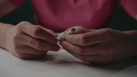 Close-up of male hands untangling tangled white usb cable sitting at desk, concept of common problem with electronic device cords and the need for better wire management. Shooting in slow motion. - Powered by Shutterstock - Get 15% off with code: PIKWIZARD15